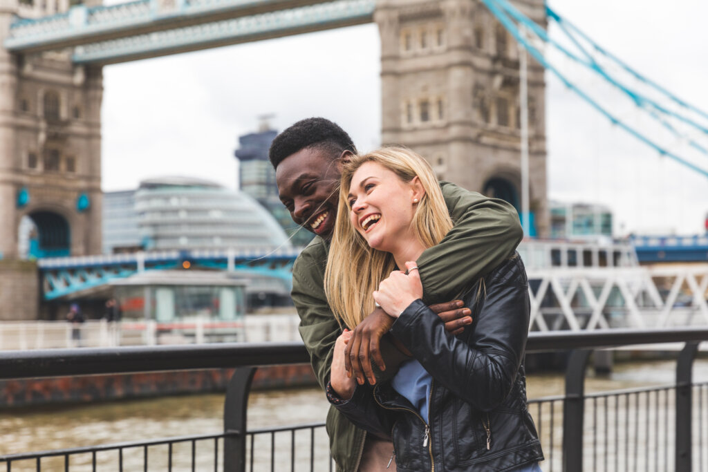 Happy couple by Tower Bridge in London, UK.